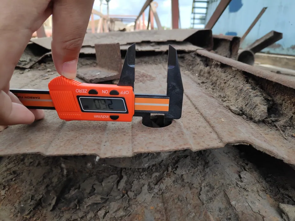 Digital caliper measuring residual plate thickness on site