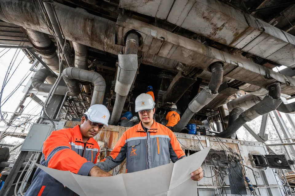 Engineers working from a general-arrangement drawing on site