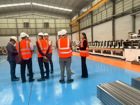 Customers and suppliers walking the collecting electrode roll-forming line at the Arrow Energy shop in Samut Sakhon