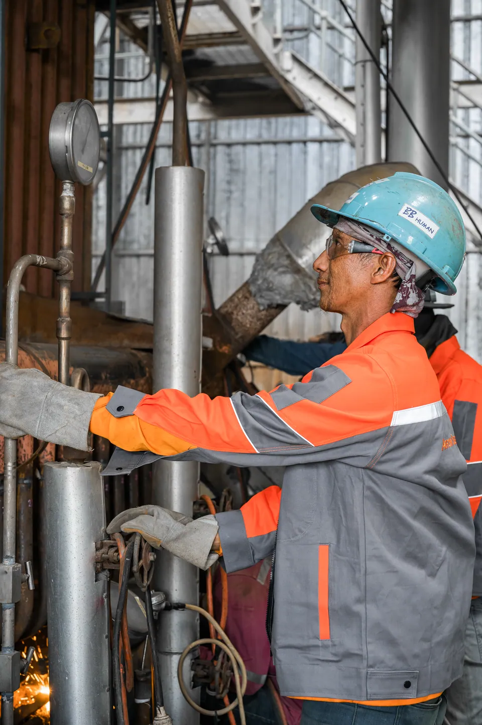 Arrow Energy technician cutting piping during a retrofit